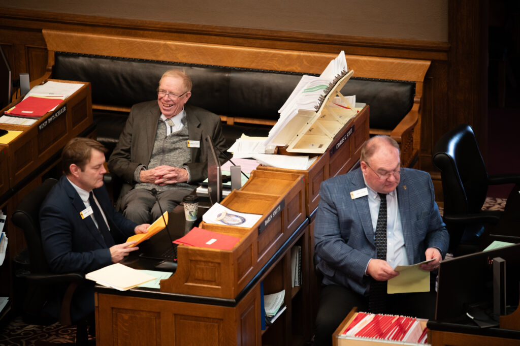 Charles Scott laughing at a joke on the floor