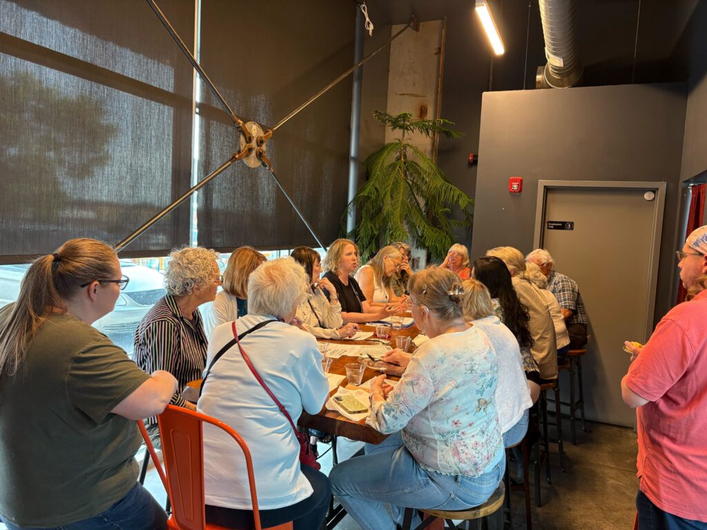 The Laramie County organizing chapter meets at a local restaurant to plan actions including canvassing their neighbors in support of mental health funding in public education