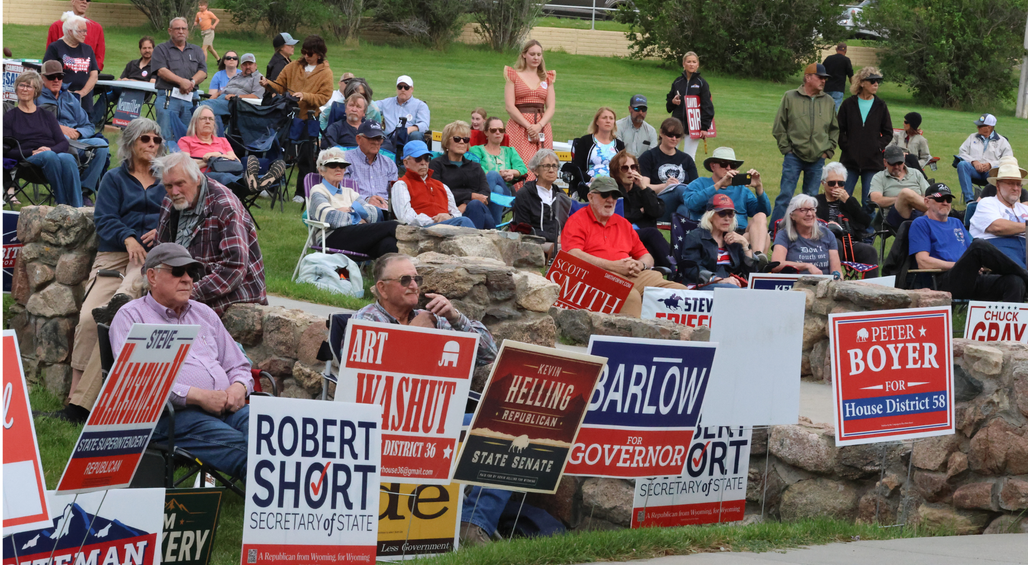 Voters gather in the park in front of yard signs