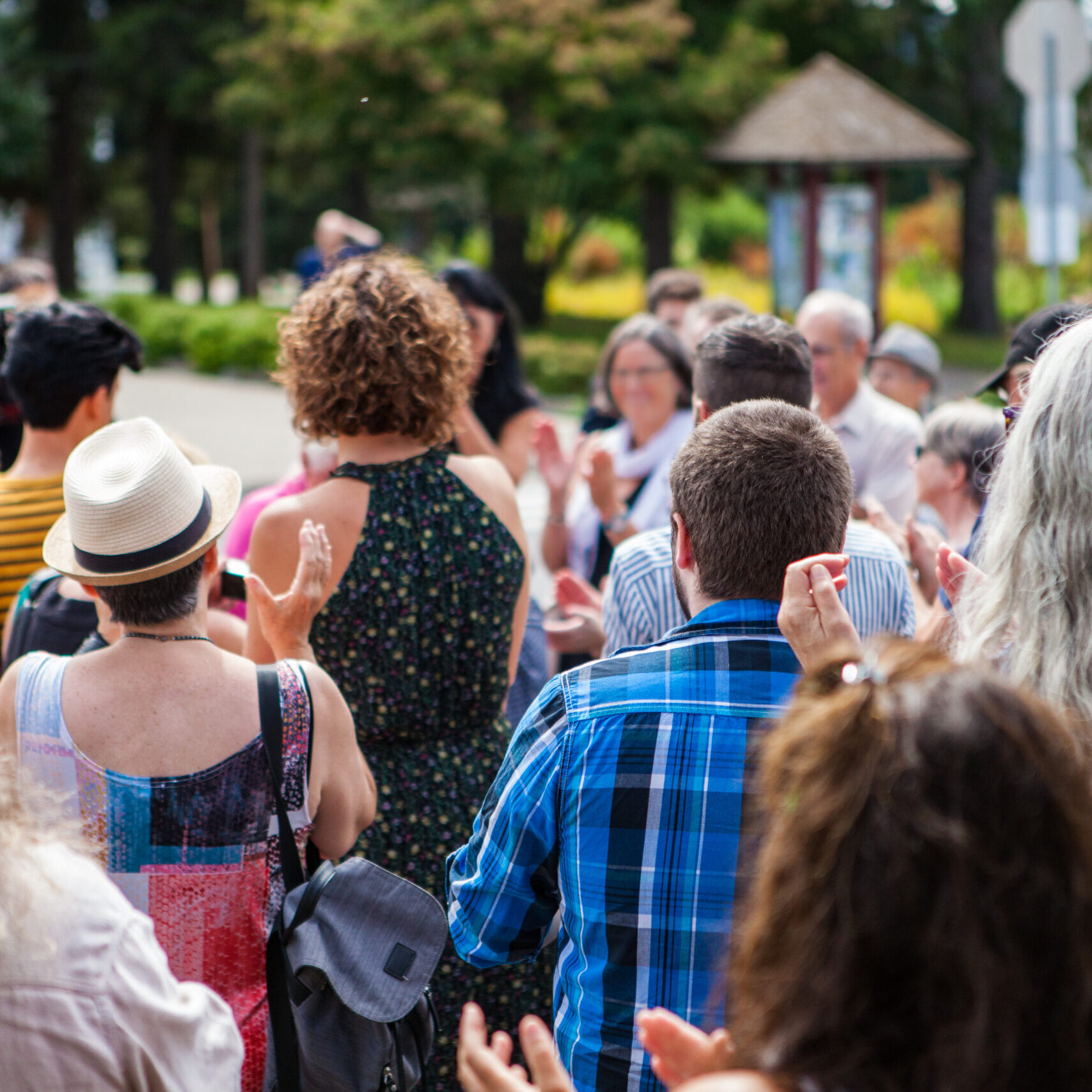 100 People applauding to a public speech given outdoors